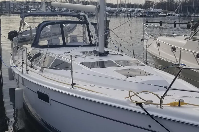 Slide: The Image of 2011 Hunter e36 sailboat docked in a marina, featuring sleek design and spacious deck. - 15