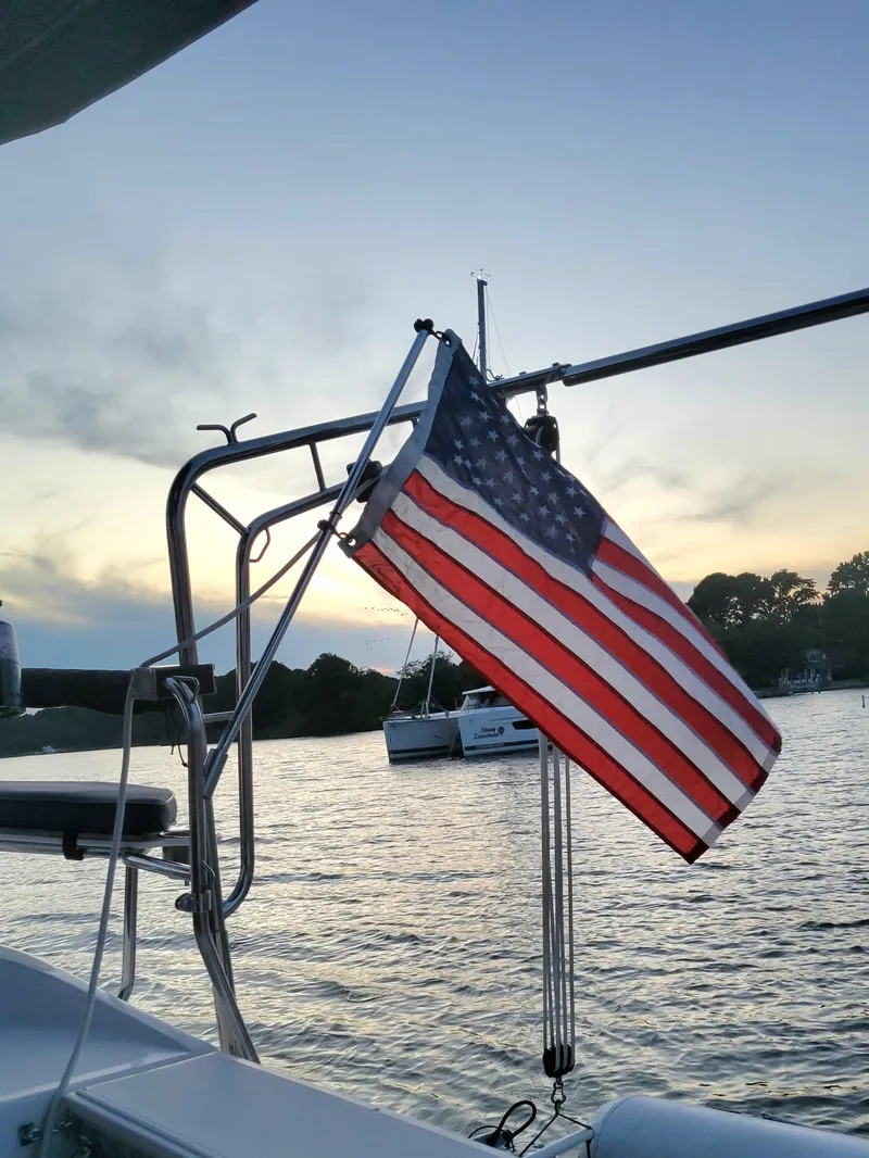 Slide: The Image of Sailboat with American flag at sunset, Hunter e36, 2011 model. - 21