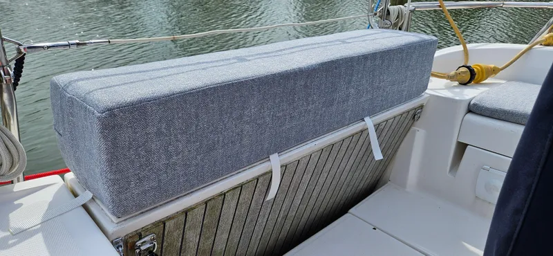 Slide: The Image of Cushioned seating on a 2011 Hunter e36 boat, with water in the background. - 22