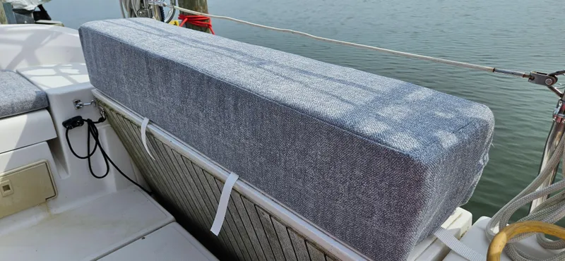 Slide: The Image of Cushioned seating on a 2011 Hunter e36 sailboat deck, overlooking calm water. - 23