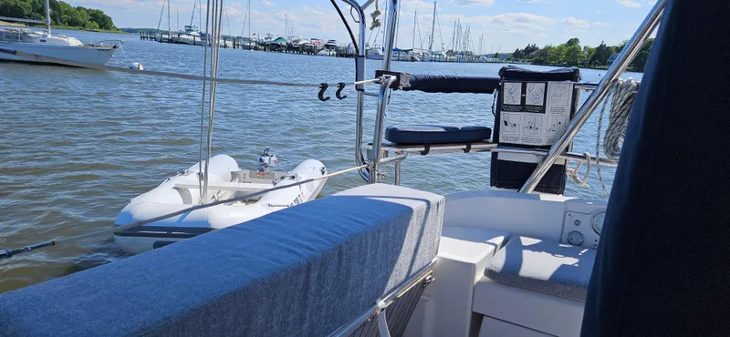 Slide: The Image of Sailboat deck view with inflatable dinghy on calm water, Hunter e36, 2011 model. - 24