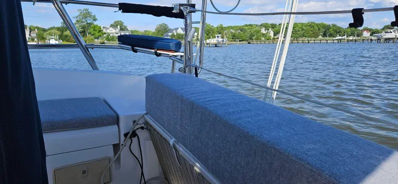 Slide: The Image of Sailboat cockpit view on water, Hunter e36, 2011 model, with blue cushions and scenic background. - 25