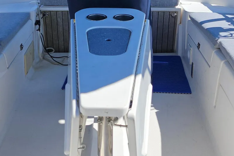 Slide: The Image of Interior of a 2011 Hunter e36 boat, featuring a cockpit with cup holders. - 28