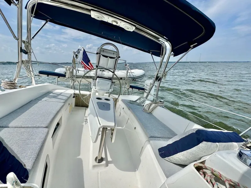 Slide: The Image of Sailboat cockpit view, Hunter e36 2011, with blue canopy and American flag on open water. - 32