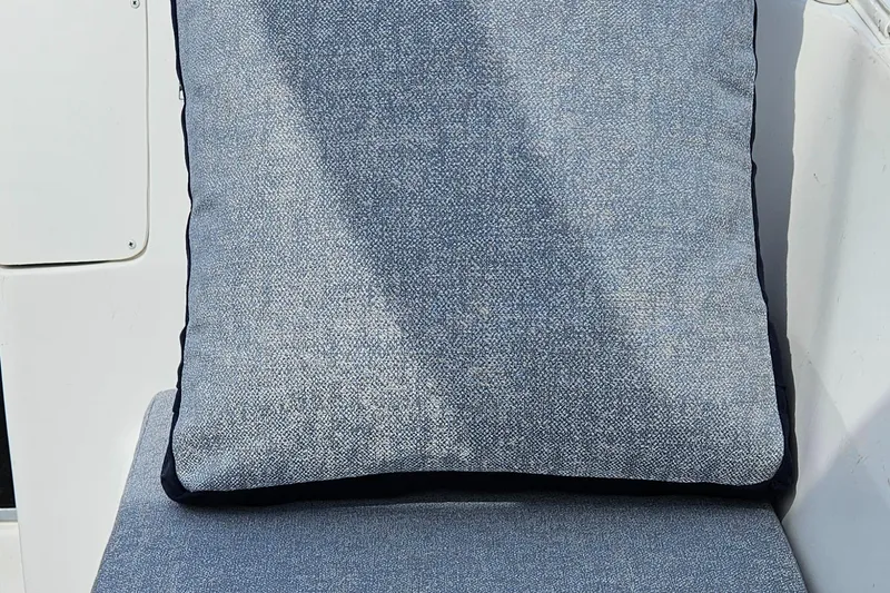 Slide: The Image of Blue cushioned seat on a 2011 Hunter e36 boat. - 36