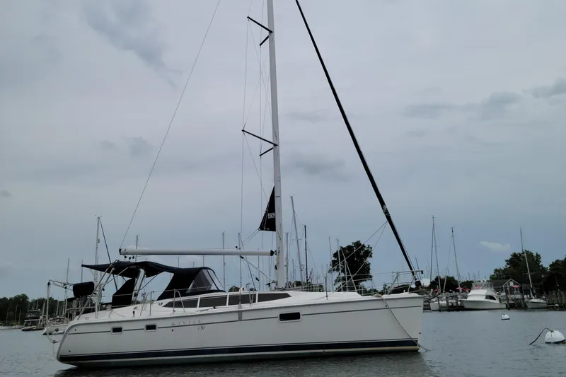 Slide: The Image of 2011 Hunter e36 sailboat docked in a marina, overcast sky. - 4