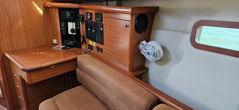 Slide: The Image of Interior of 2011 Hunter e36 sailboat with navigation station and wooden cabinetry. - 42