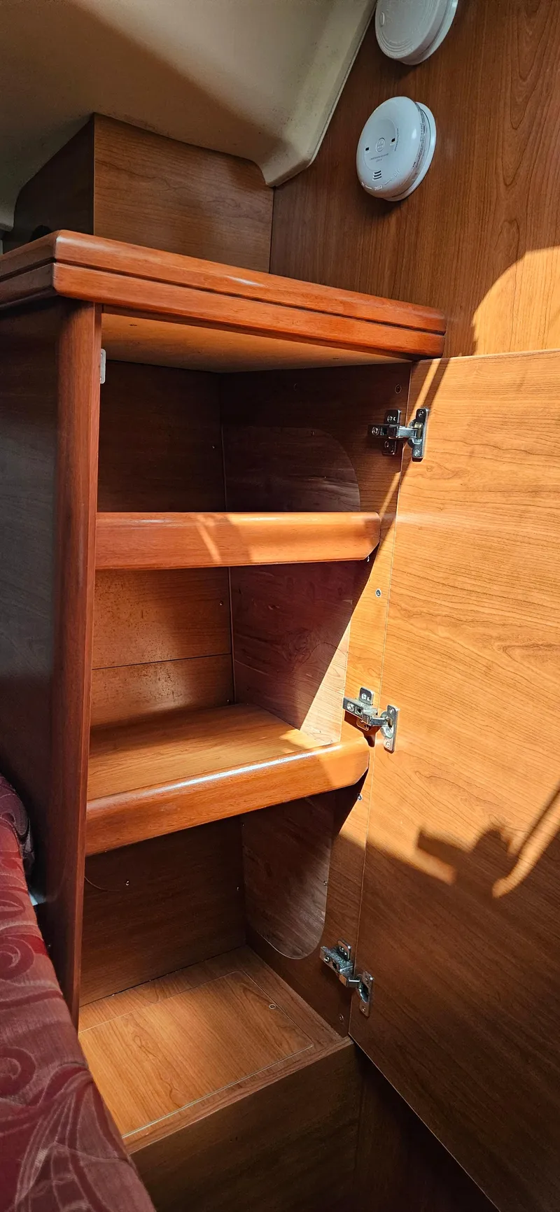 Slide: The Image of Wooden cabinet with open shelves inside a 2011 Hunter e36 boat interior. - 43