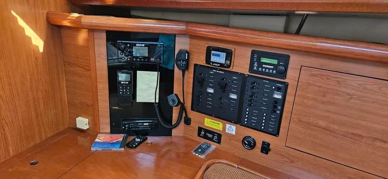 Slide: The Image of Control panel of 2011 Hunter e36 boat with communication equipment and switches. - 44