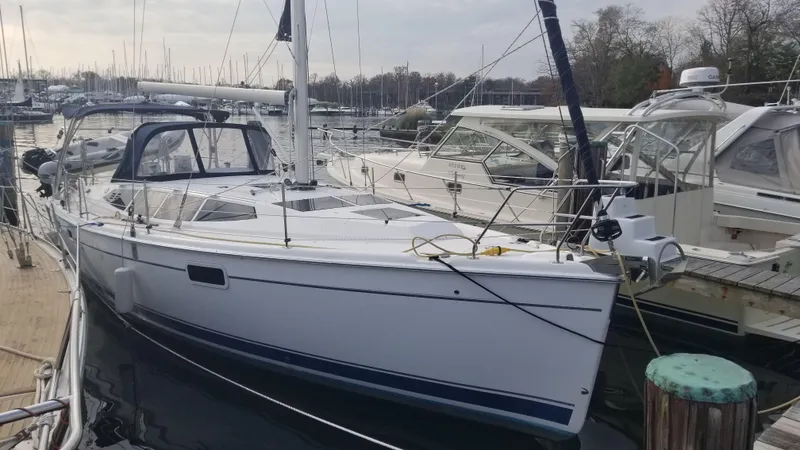 Slide: The Image of 2011 Hunter e36 sailboat docked at marina, surrounded by other boats. - 6
