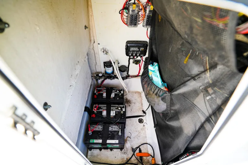 Slide: The Image of 2019 Sportsman 232 Open Platinum boat battery compartment with wiring and electrical components. - 16