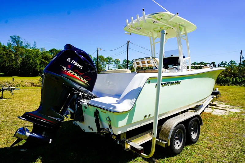 Slide: The Image of 2019 Sportsman 232 Open Platinum boat on trailer with Yamaha engine, parked on grass. - 17