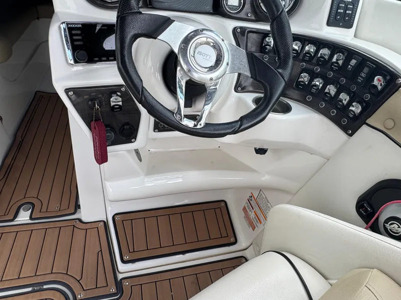 Slide: The Image of 2017 Rinker QX29 BR boat cockpit with steering wheel and control panel. - 10