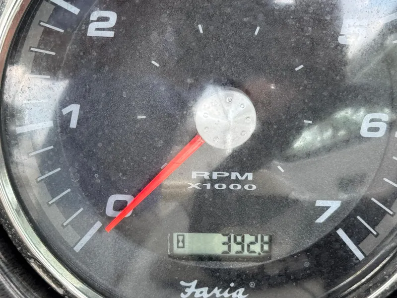 Slide: The Image of Close-up of a 2017 Rinker QX29 BR tachometer showing 392.1 hours. - 11