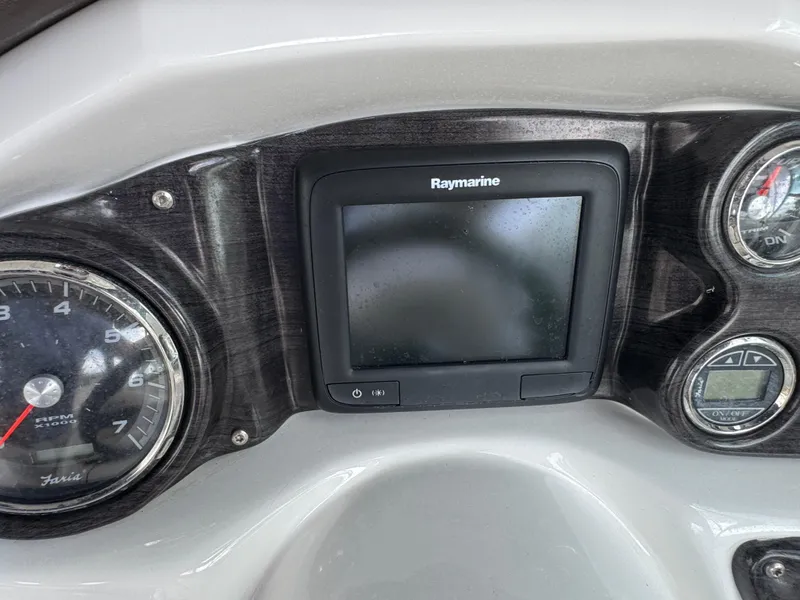 Slide: The Image of Dashboard of 2017 Rinker QX29 BR boat with Raymarine display and gauges. - 14