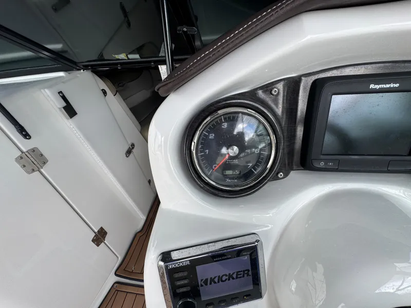 Slide: The Image of 2017 Rinker QX29 BR boat dashboard with gauges and Raymarine display. - 16