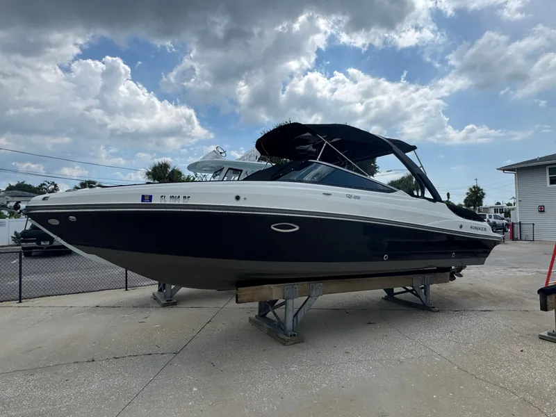 Slide: The Image of 2017 Rinker QX29 BR boat on display under cloudy sky. - 23