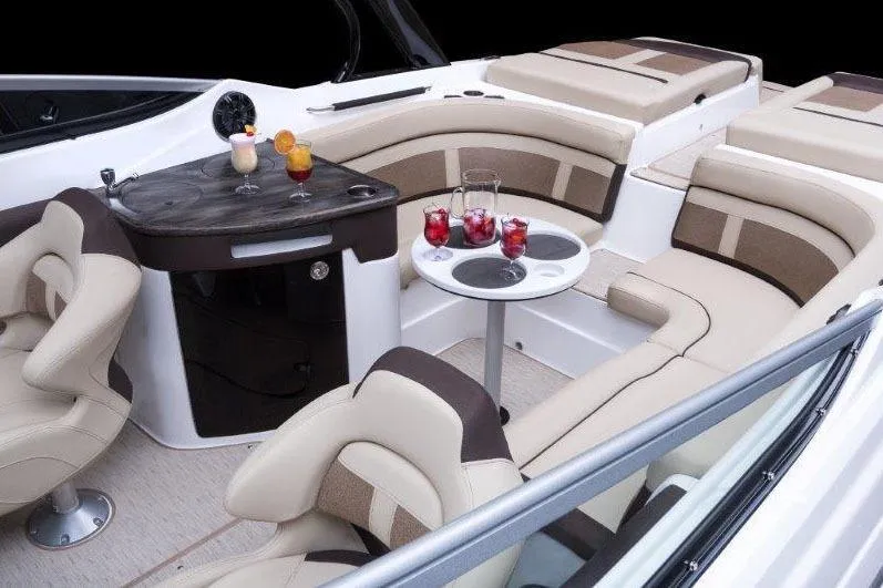 Slide: The Image of 2017 Rinker QX29 BR boat interior with luxurious seating and drinks on tables. - 27