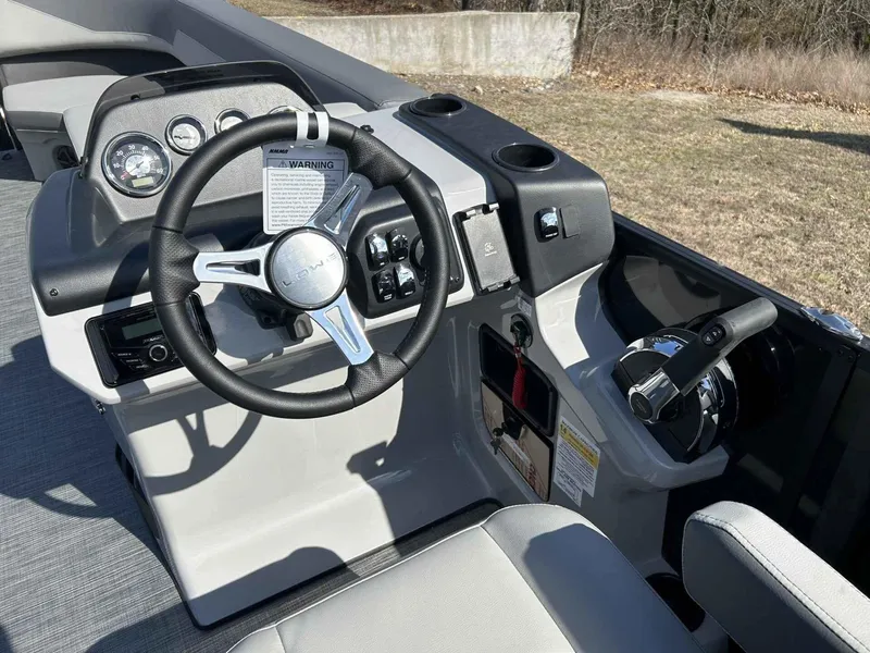 Slide: The Image of 2025 Lowe LS 230 boat dashboard with steering wheel and control panel. - 6