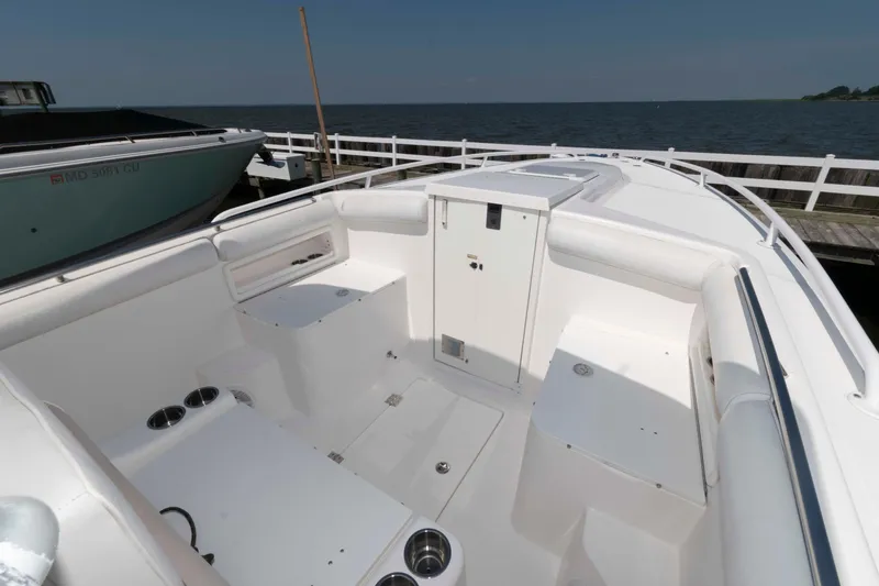 Slide: The Image of 2008 Marlago FS 35 Center Console Cuddy boat interior, docked by the water. - 12
