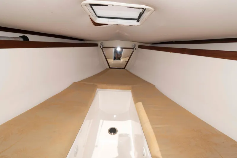 Slide: The Image of 2008 Marlago FS 35 Center Console Cuddy interior with beige cushions and overhead hatch. - 14