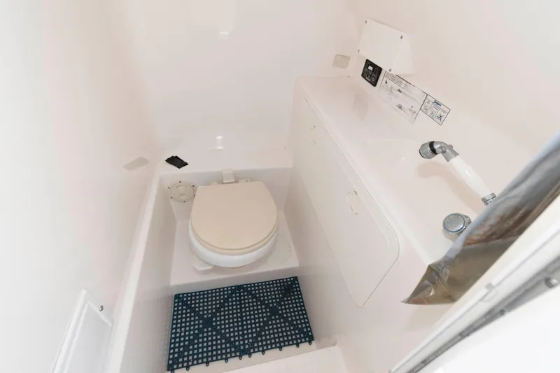 Slide: The Image of 2008 Marlago FS 35 Center Console Cuddy boat interior with compact marine toilet. - 15