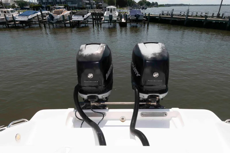 Slide: The Image of 2008 Marlago FS 35 Center Console Cuddy with twin Mercury outboard engines at a marina. - 16