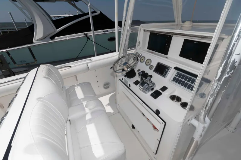 Slide: The Image of 2008 Marlago FS 35 Center Console Cuddy with white seating and modern dashboard controls. - 5