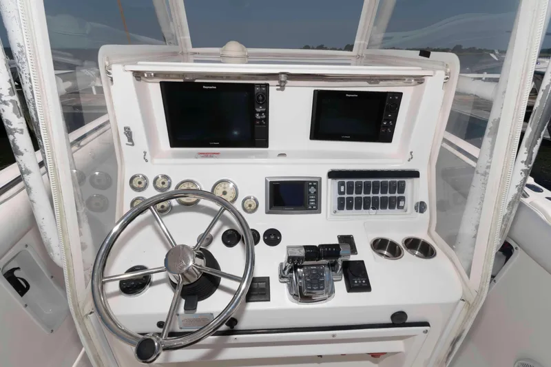 Slide: The Image of 2008 Marlago FS 35 Center Console Cuddy dashboard with steering wheel and navigation controls. - 8