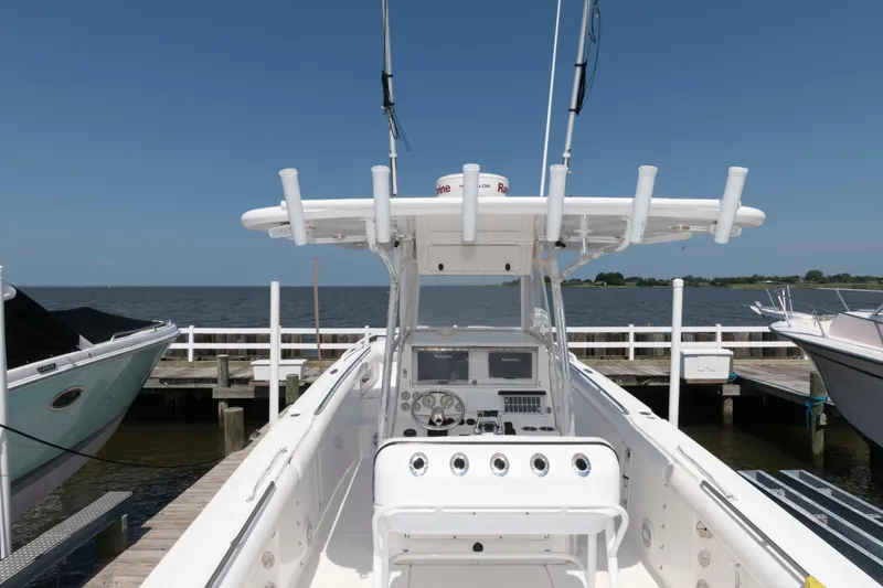 Slide: The Image of 2008 Marlago FS 35 Center Console Cuddy boat docked by the water. - 9
