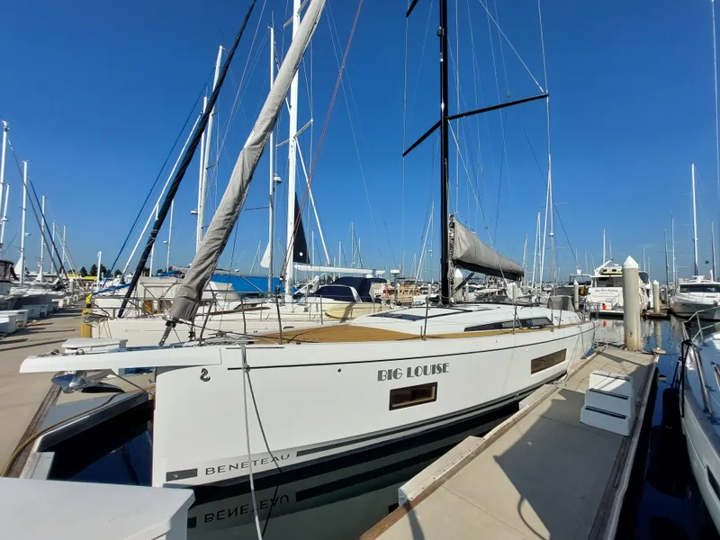 Slide: The Image of 2022 Beneteau Oceanis 46.1 sailboat docked at marina under clear blue sky. - 0