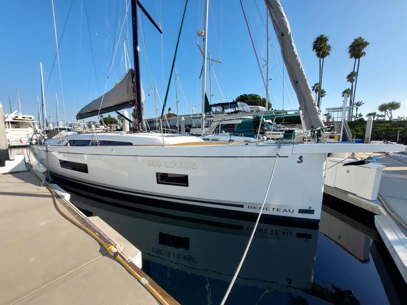 Slide: The Image of 2022 Beneteau Oceanis 46.1 yacht docked at marina under clear blue sky. - 1