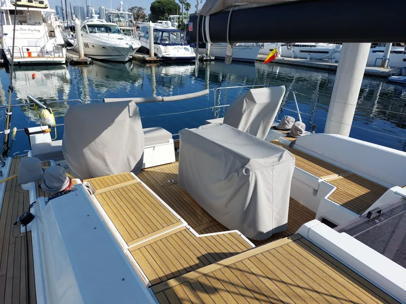 Slide: The Image of Beneteau Oceanis 46.1 yacht deck, 2022 model, docked at marina with covered seating. - 10