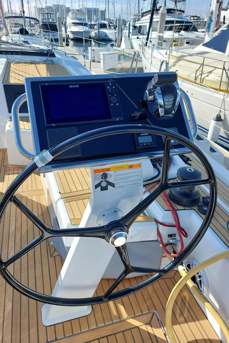 Slide: The Image of Beneteau Oceanis 46.1 2022 yacht helm with navigation equipment and teak deck. - 11