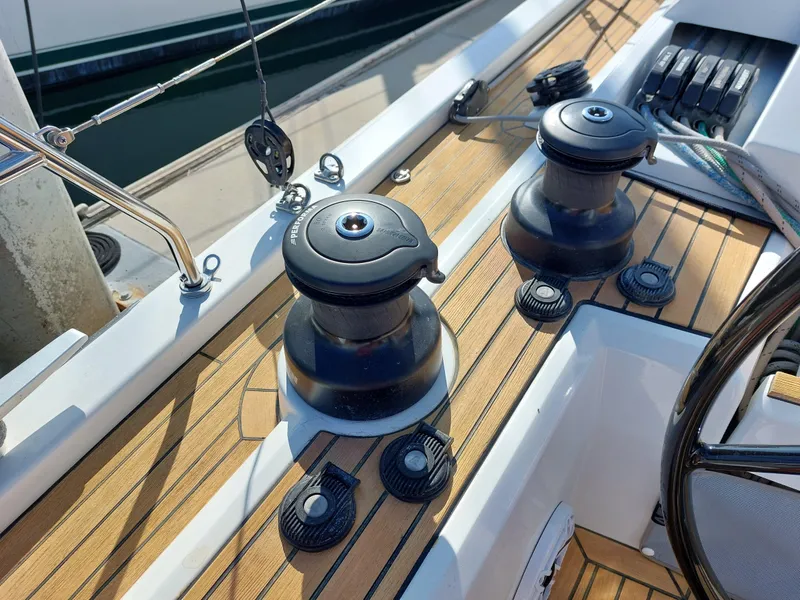 Slide: The Image of Beneteau Oceanis 46.1 2022 yacht deck with winches and teak finish. - 13