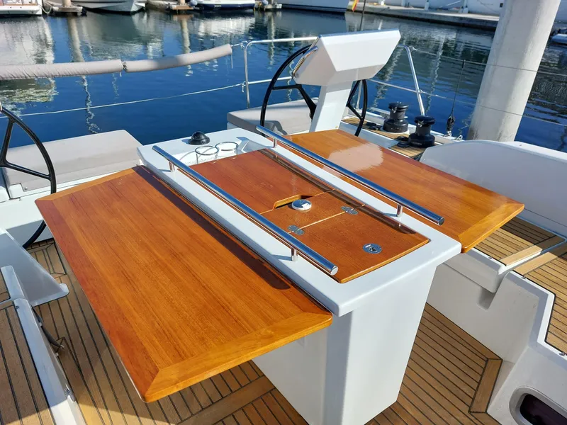 Slide: The Image of Beneteau Oceanis 46.1 yacht cockpit with wooden table, 2022 model, docked at marina. - 17