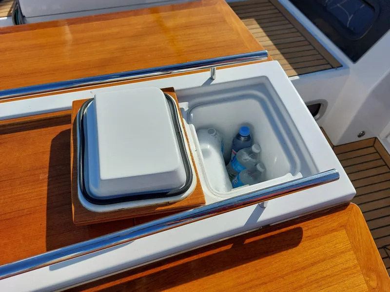Slide: The Image of Beneteau Oceanis 46.1 2022 yacht deck with built-in cooler and drinks. - 18