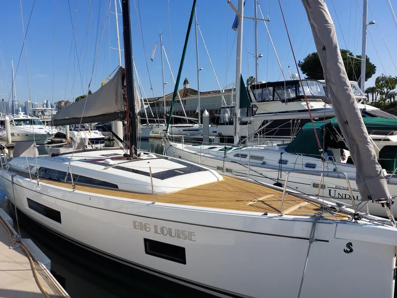 Slide: The Image of 2022 Beneteau Oceanis 46.1 sailboat docked at marina, featuring sleek design and spacious deck. - 2