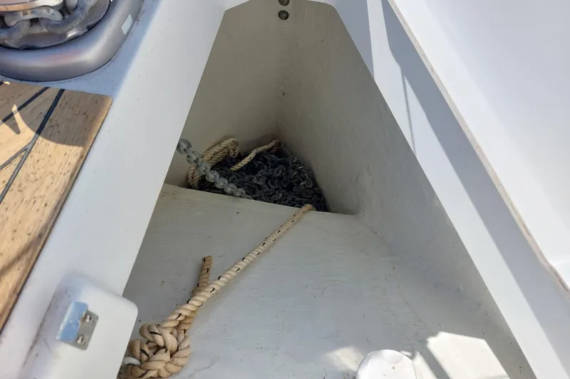Slide: The Image of Anchor locker of 2022 Beneteau Oceanis 46.1 sailboat with ropes and chains. - 23