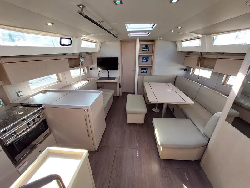 Slide: The Image of Interior of 2022 Beneteau Oceanis 46.1 yacht, featuring modern kitchen and spacious seating area. - 24