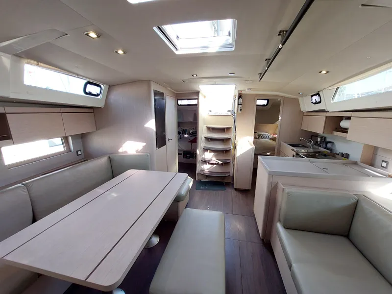 Slide: The Image of Interior of 2022 Beneteau Oceanis 46.1 yacht, featuring modern dining and kitchen area. - 25