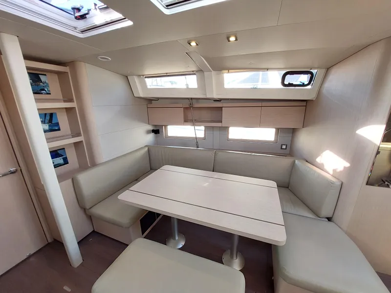 Slide: The Image of Interior of 2022 Beneteau Oceanis 46.1 yacht with modern seating and dining area. - 26