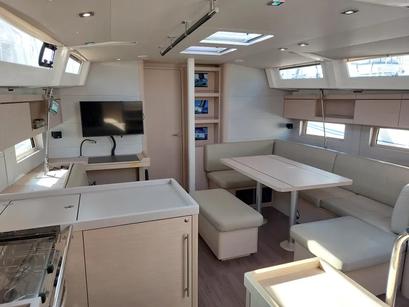 Slide: The Image of Interior of 2022 Beneteau Oceanis 46.1 yacht, featuring modern kitchen and dining area. - 27