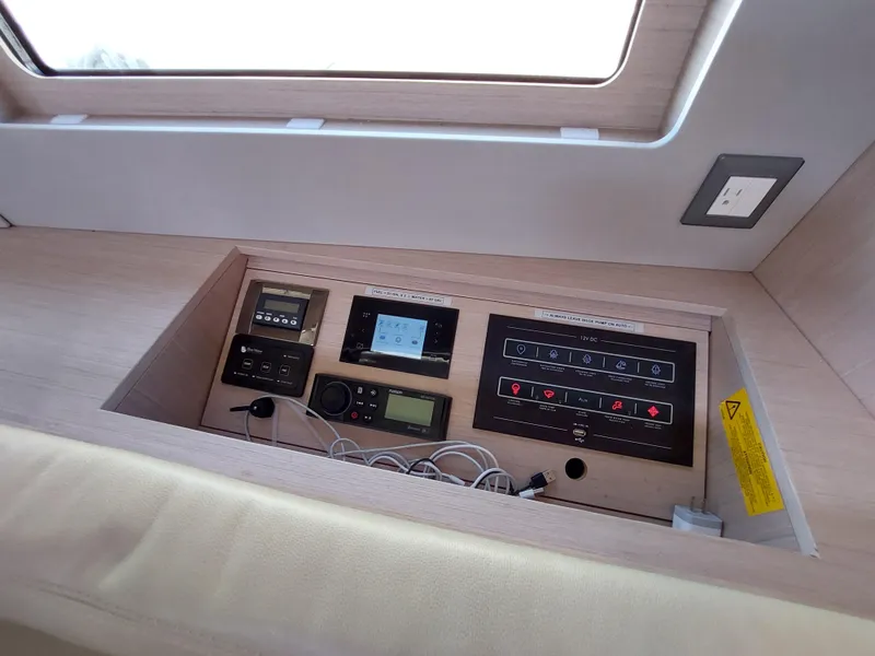Slide: The Image of Control panel inside 2022 Beneteau Oceanis 46.1 yacht, featuring modern navigation and communication equipment. - 28