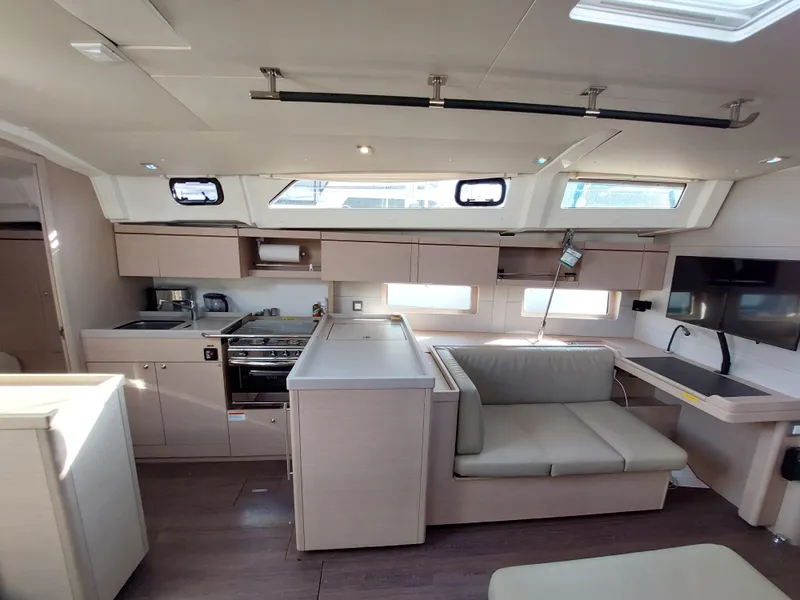 Slide: The Image of Modern interior of 2022 Beneteau Oceanis 46.1 yacht with kitchen and seating area. - 30