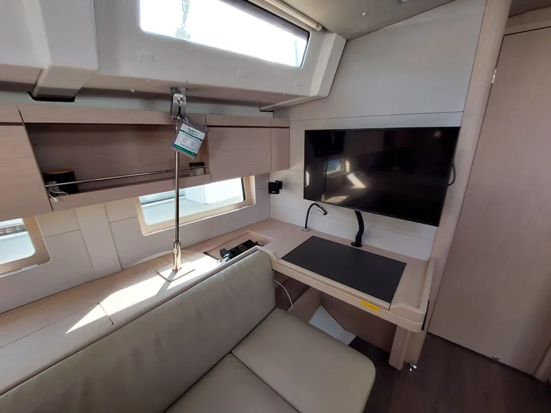 Slide: The Image of Interior of 2022 Beneteau Oceanis 46.1 yacht with modern seating and entertainment area. - 31