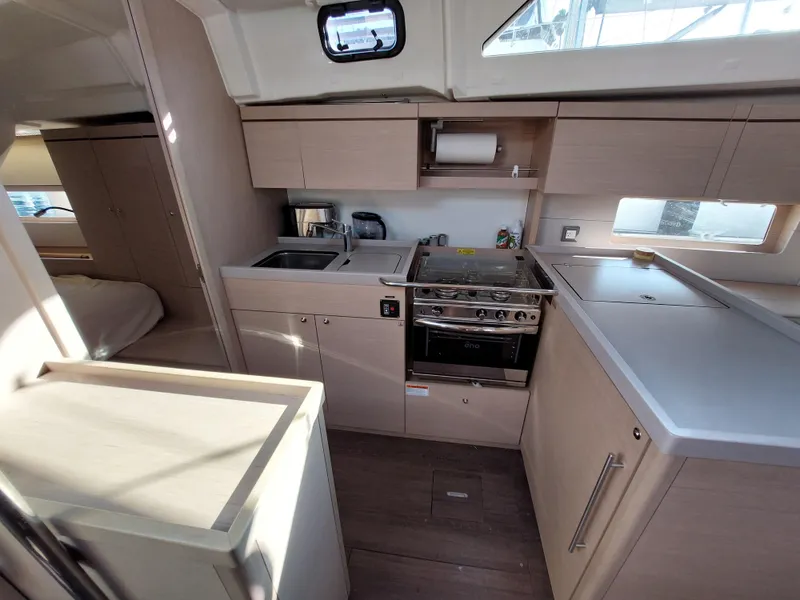 Slide: The Image of Modern kitchen interior of 2022 Beneteau Oceanis 46.1 yacht, featuring sleek cabinetry and appliances. - 33