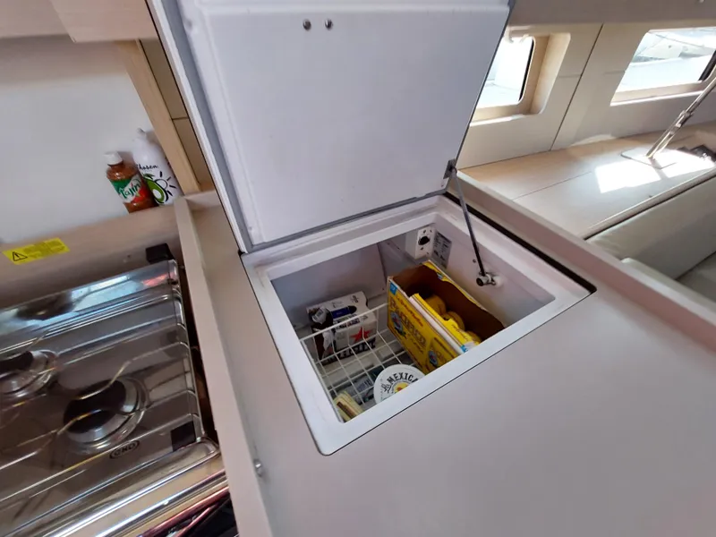 Slide: The Image of Interior view of 2022 Beneteau Oceanis 46.1 yacht kitchen with open storage compartment. - 35