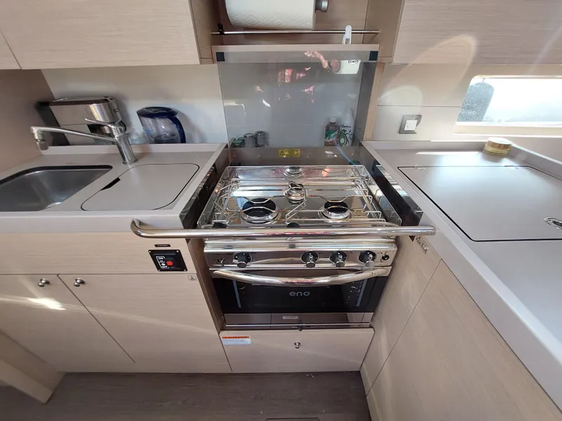 Slide: The Image of Modern kitchen in 2022 Beneteau Oceanis 46.1 yacht with stove and sink. - 36