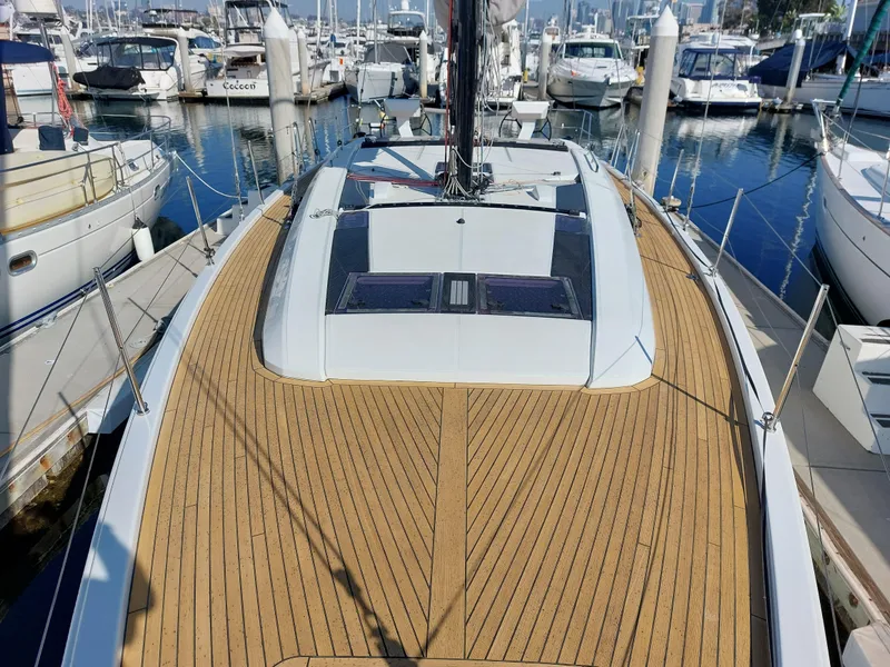 Slide: The Image of Beneteau Oceanis 46.1 2022 yacht with teak deck, docked in a marina. - 4